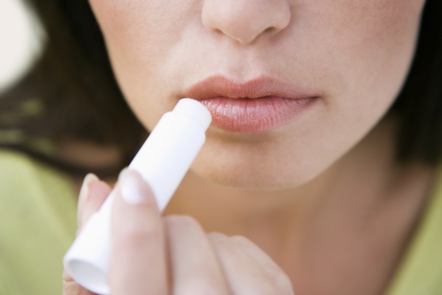 Woman applying chapstick