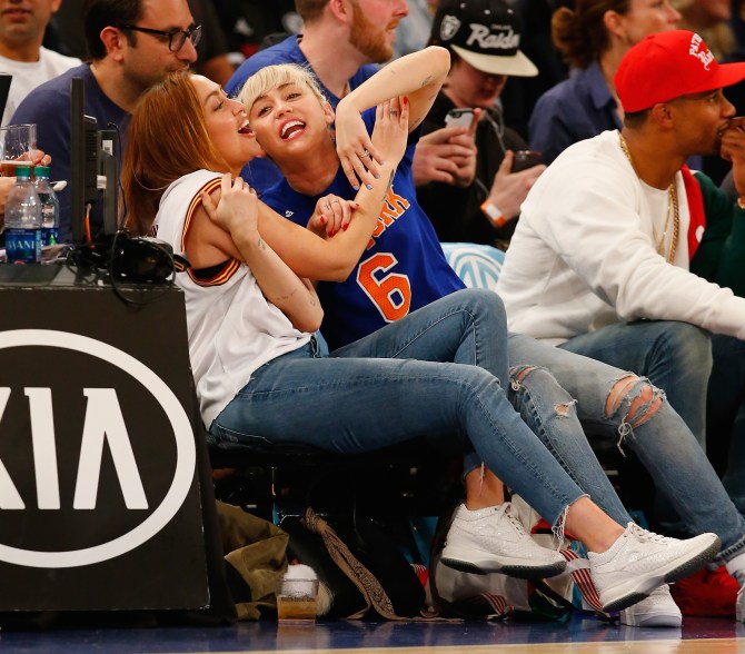 NEW YORK, NY - MARCH 26: Miley Cyrus looks on with her sister Brandi during the game between the New York Knicks and the Cleveland Cavaliers at Madison Square Garden on March 26, 2016 in New York City. NOTE TO USER: User expressly acknowledges and agrees that, by downloading and/or using this Photograph, user is consenting to the terms and conditions of the Getty Images License Agreement. (Photo by Al Bello/Getty Images)