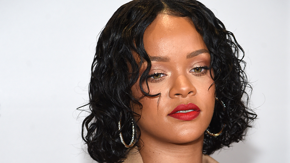 Rihanna Makeup: Rihanna sports red lips with a tousled bob.