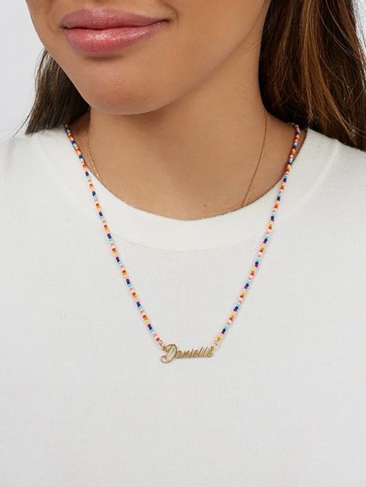 STYLECASTER | Word and Name Jewelry Is Having a Moment, Because Carrie Bradshaw Is a Forever Fashion Icon