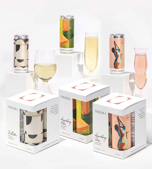 Several glasses of wine displayed next to wine cans and wine boxes