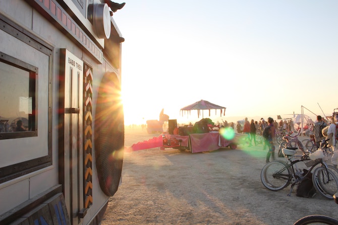 A campsite at Burning Man with several people and bikes