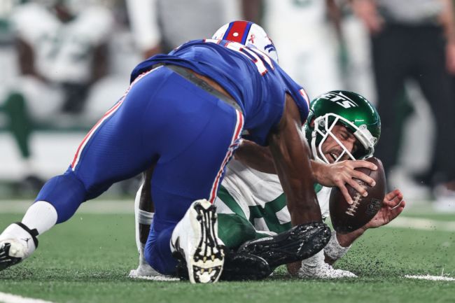 Aaron Rodgers #8 of the New York Jets reacts as he sacked by Leonard Floyd #56 of the Buffalo Bills during a game at MetLife Stadium on September 11, 2023 in East Rutherford, New Jersey.