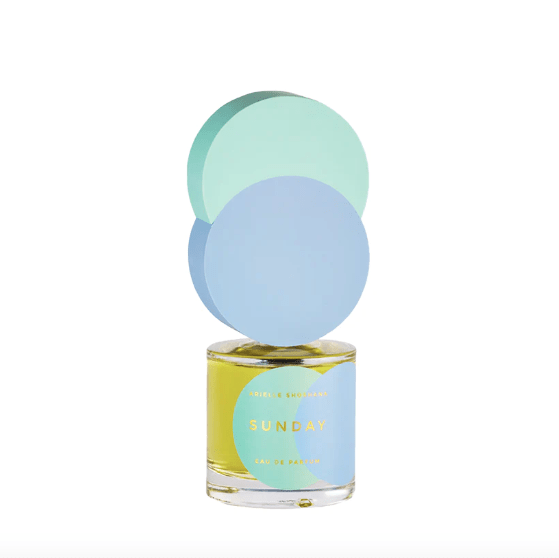 Arielle Shoshana's Sunday perfume in a clear bottle with a blue and teal circle as the cap