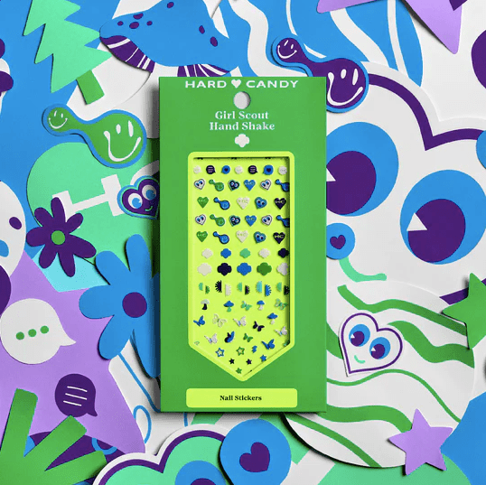 A box of Hard Candy x Girl Scouts Hand Shake Nail Stickers over a patterned background