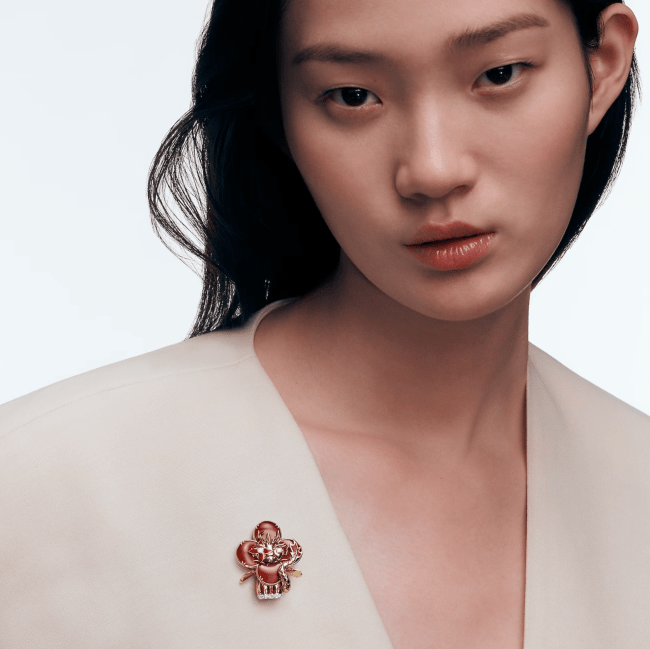 A model wearing a dragon pendant from Louis Vuitton