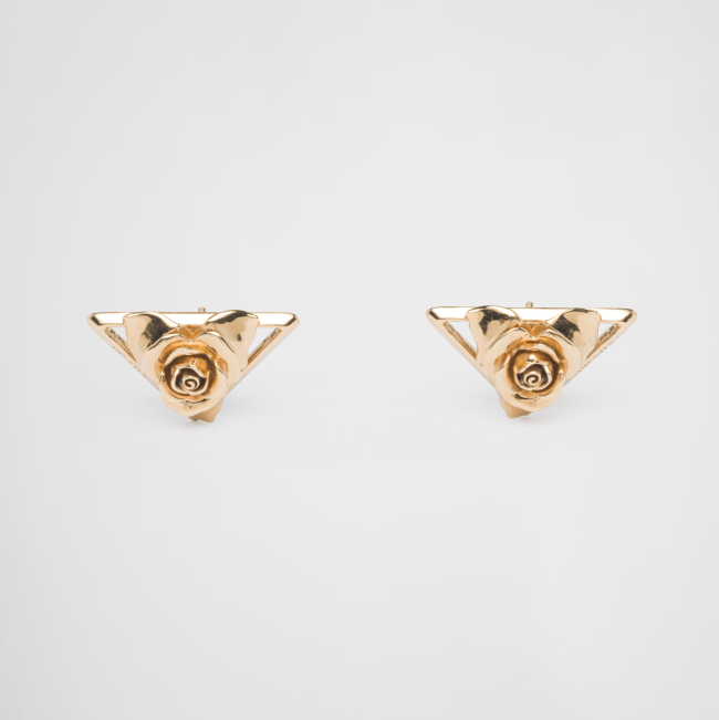 A pair of gold triangle earrings decorated with roses from Prada