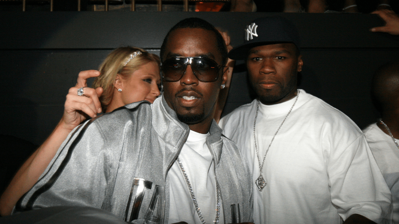 Photo of rappers 50 Cent and P Diddy at a party with Paris Hilton in the background