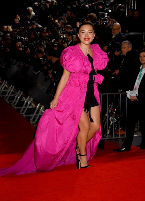Florence Pugh in a black mini dress and hot pink cape at the 2020 British Academy Film Awards red carpet