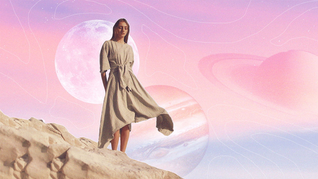 A woman standing on a cliffs edge with planets floating behind her in a pink sky, thinking about her weekly horoscope