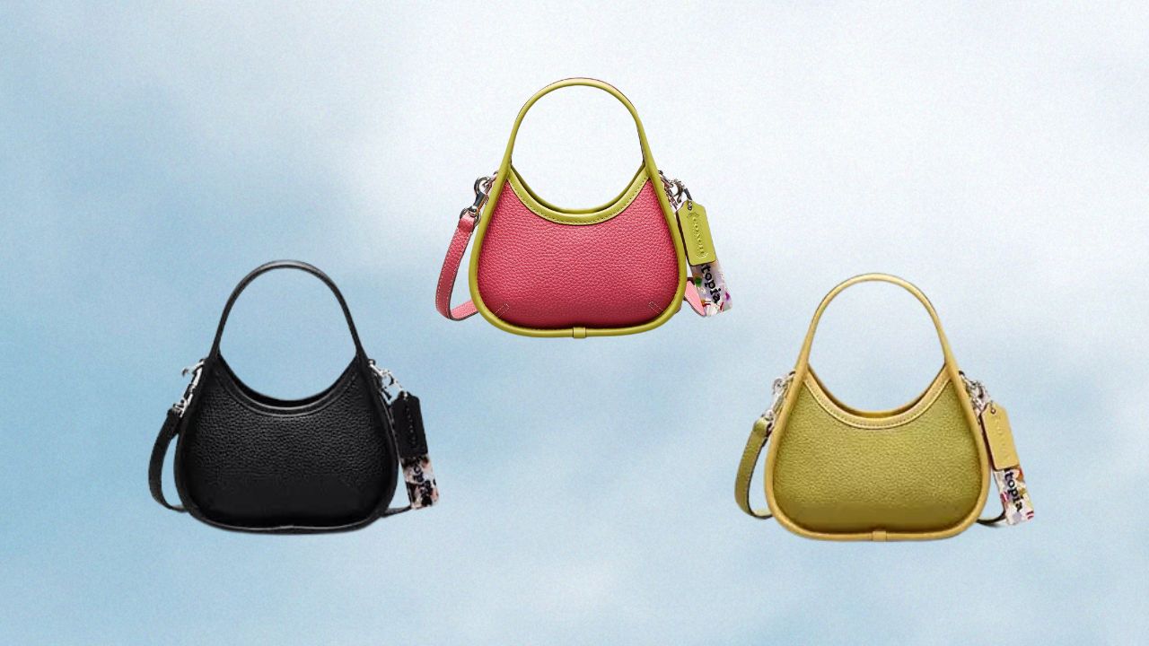 Three mini COACH Ergo Bags in pink, green, and black against a cloud backdrop.
