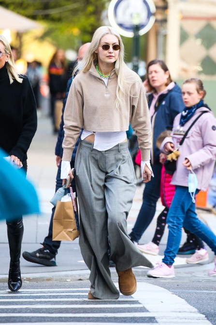 Gigi Hadid is seen in a cropped quarter zip sweater, baggy gray trousers, and brown Ugg boots on April 22, 2022 in New York City.