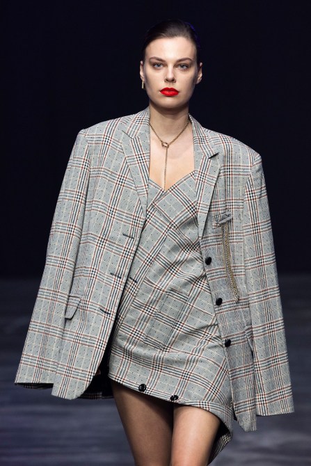 A model wearing a plaid blazer.