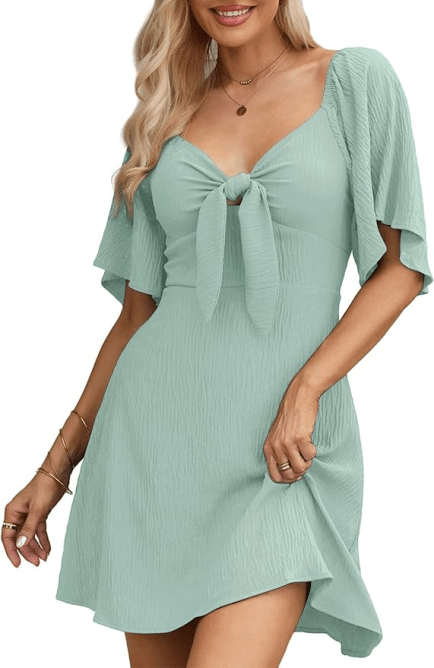 A model wearing the Dokotoo Tie Mini Dress in a seafoam green colorway