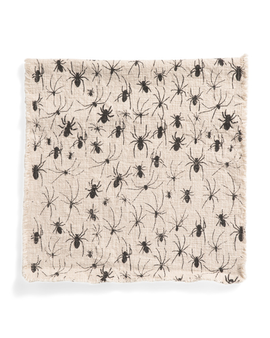 Cream table runner with spiders on it