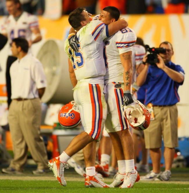 Florida QB Tim Tebow (15) victorious, hugging teammate Aaron Hernandez (81) during game vs Oklahoma. Miami, FL