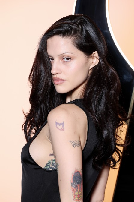 Gabbriette wearing a cool toned smokey eye and thin brows.