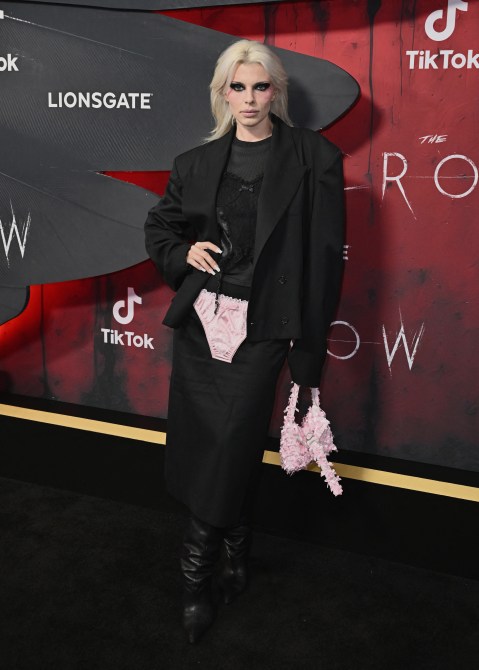 Julia Fox wearing pink underwear over a black skirt.