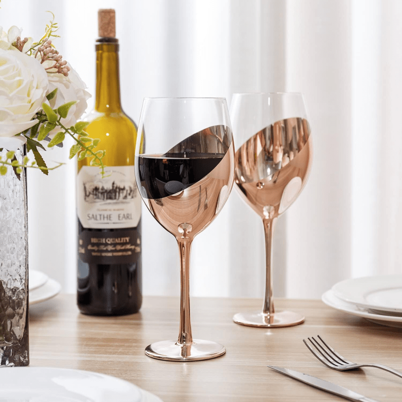 MyGift 14 oz Copper-Toned Stemmed Wine Glass Set of 4 on a dining table with wine