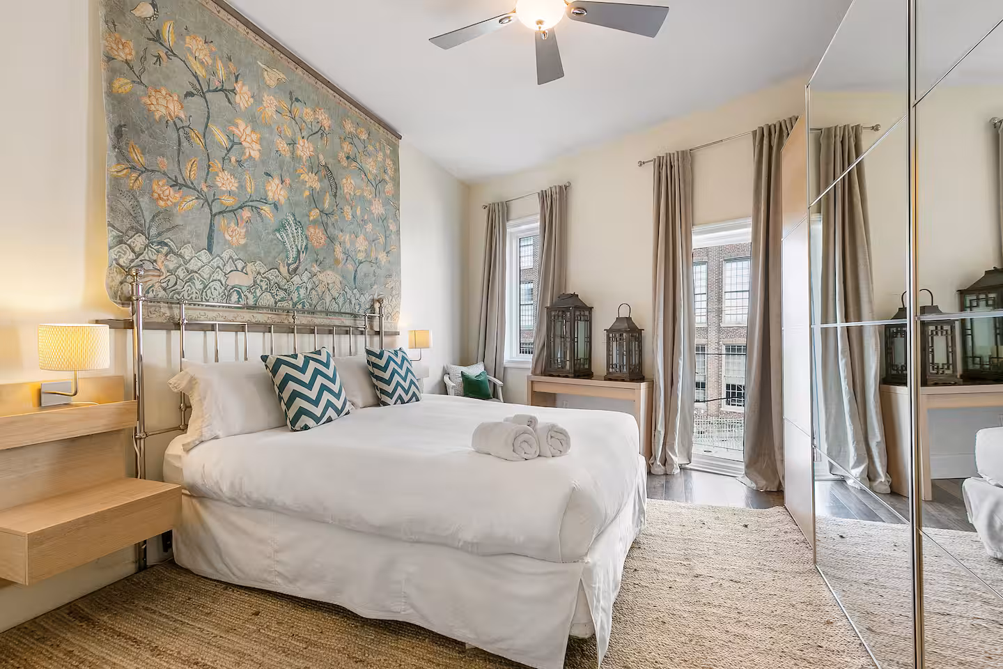 Bedroom with a large painting hanging over a bed
