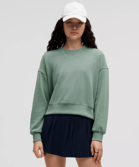 A model wearing the Lululemon Softstreme Perfectly Oversized Cropped Crew in a seafoam green colorway