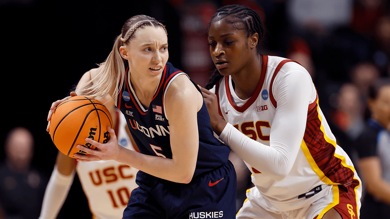SPOKANE, WASHINGTON - MARCH 31: Paige Bueckers #5 of the UConn Huskies makes a move on Clarice Akunwafo #34 of the USC Trojans during the second half in the Elite Eight round of the NCAA Women's Basketball Tournament at Spokane Arena on March 31, 2025 in Spokane, Washington.