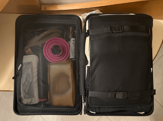 The inside of Jenzia Burgos' packed Quince Small Carry-On Suitcase