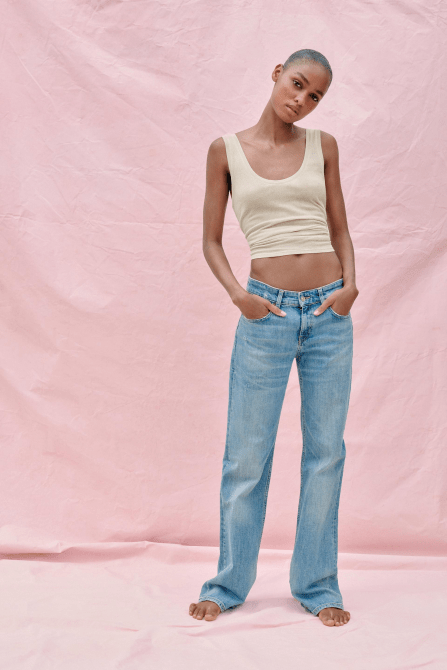 A model wearing the Zara TRF Low Rise Bootcut Jeans in a medium wash