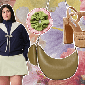 A floral background with a green crescent-shaped bag, brown block heels, a green scrunchie, and a woman wearing a navy jacket with a white bow.