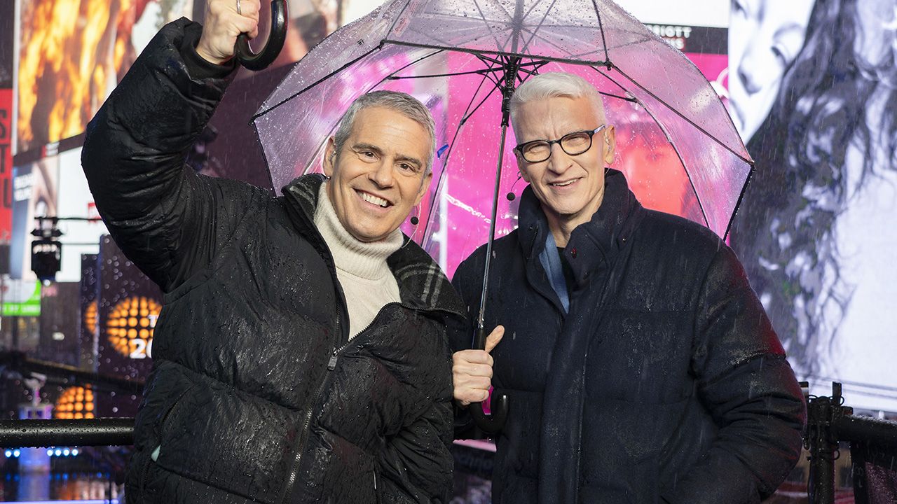 NEW YORK, NEW YORK - DECEMBER 31: Andy Cohen and Anderson Cooper host CNN's New Year's Eve coverage in the rain in Times Square on December 31, 2024 in New York City.