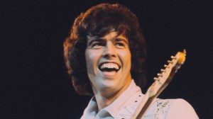 Musician and guitarist Alan Osmond performs live on stage with American family pop group The Osmonds on the British leg of their European tour, October 1973.